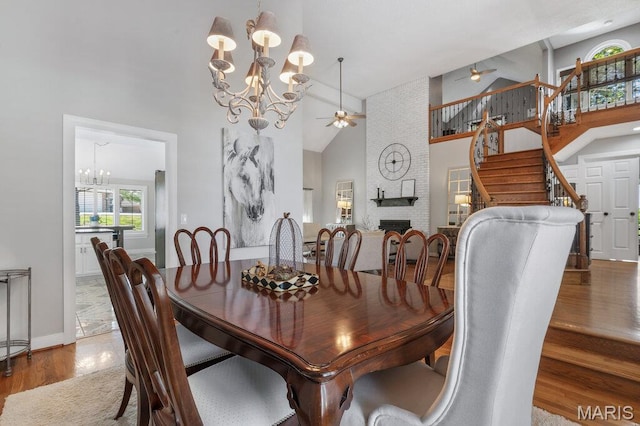 108 Lucys Lndg, Waterloo, IL 62298 - dining room featuring a chandelier, ceiling fan, high vaulted ceiling, stairway, and wood finished floors