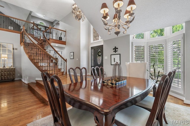 108 Lucys Lndg, Waterloo, IL 62298 - dining room featuring stairs, plenty of natural light, light wood finished floors, a chandelier, and a towering ceiling
