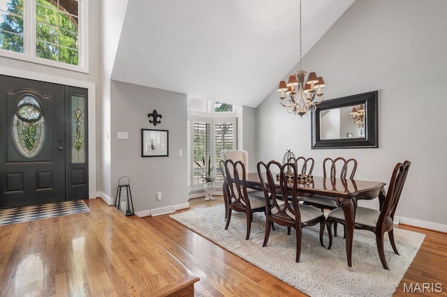 108 Lucys Lndg, Waterloo, IL 62298 - dining area featuring high vaulted ceiling, a chandelier, and light wood-style flooring