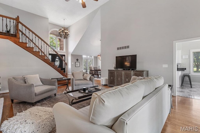 108 Lucys Lndg, Waterloo, IL 62298 - living area featuring stairs, a high ceiling, a chandelier, wood finished floors, and a ceiling fan
