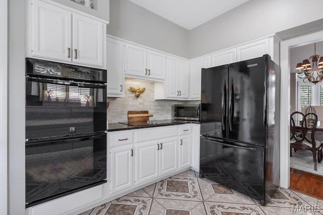 108 Lucys Lndg, Waterloo, IL 62298 - kitchen with black appliances, a chandelier, white cabinets, decorative backsplash, and a textured ceiling