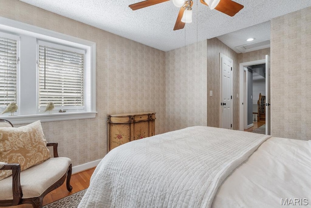108 Lucys Lndg, Waterloo, IL 62298 - bedroom featuring wood finished floors, wallpapered walls, a textured ceiling, and ceiling fan