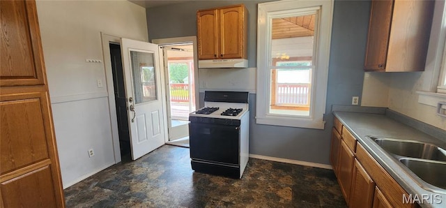 1629 Swanwick St, Chester, IL 62233 - kitchen with range with gas cooktop, under cabinet range hood, brown cabinetry, a sink, and baseboards