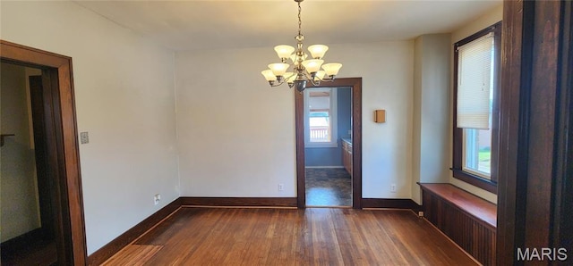 1629 Swanwick St, Chester, IL 62233 - empty room with a chandelier, dark wood-type flooring, and baseboards