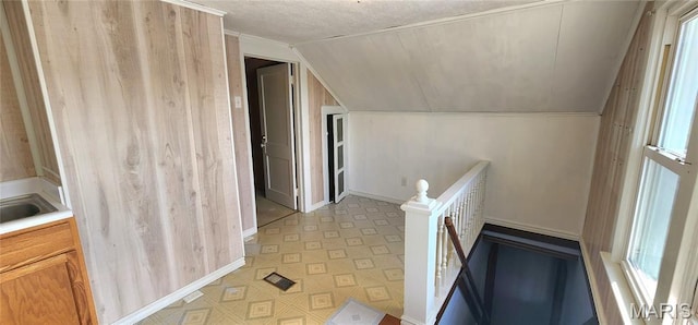 1629 Swanwick St, Chester, IL 62233 - hallway with lofted ceiling, light floors, an upstairs landing, baseboards, and a textured ceiling