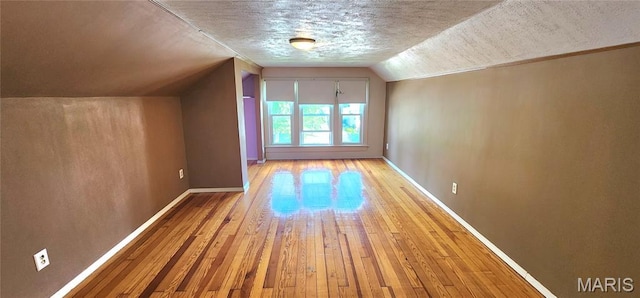 1629 Swanwick St, Chester, IL 62233 - additional living space featuring hardwood / wood-style floors, lofted ceiling, baseboards, and a textured ceiling