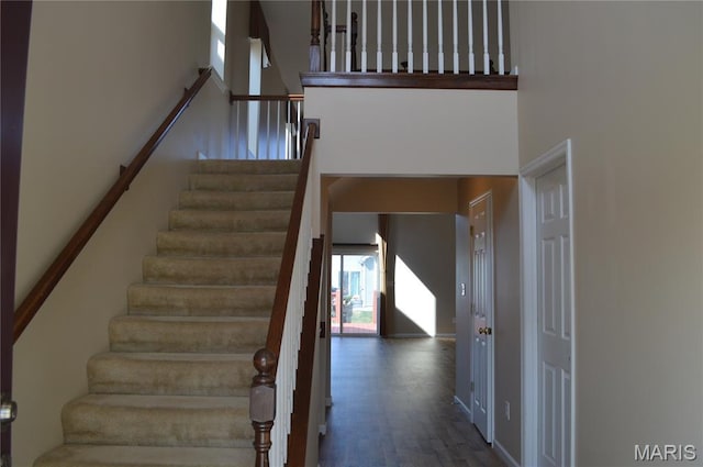 1313 Commons Cir, Cottleville, MO 63304 - stairway with healthy amount of natural light, a high ceiling, and wood finished floors