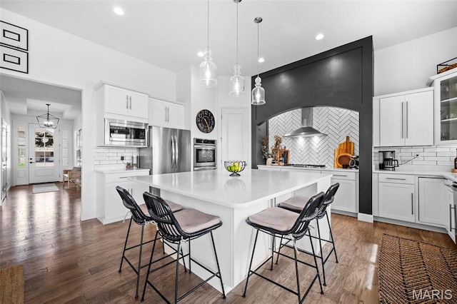 932 Colebrook Ct, Lake St Louis, MO 63367 - kitchen featuring stainless steel appliances, tasteful backsplash, light countertops, a breakfast bar area, and recessed lighting