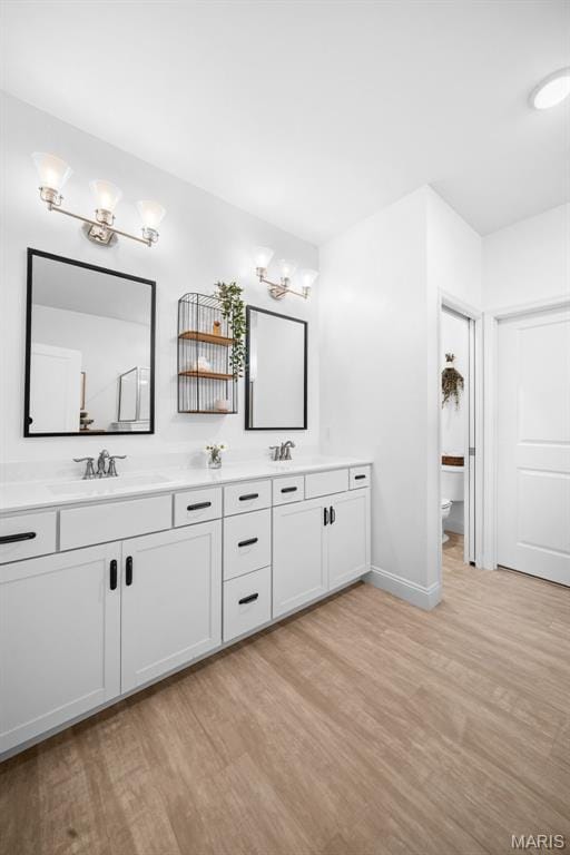 932 Colebrook Ct, Lake St Louis, MO 63367 - bathroom featuring wood finished floors and double vanity