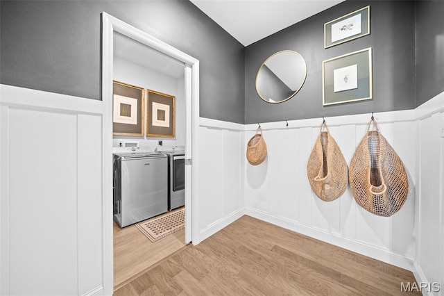 932 Colebrook Ct, Lake St Louis, MO 63367 - hall featuring washer and dryer, light wood-style flooring, wainscoting, and a decorative wall