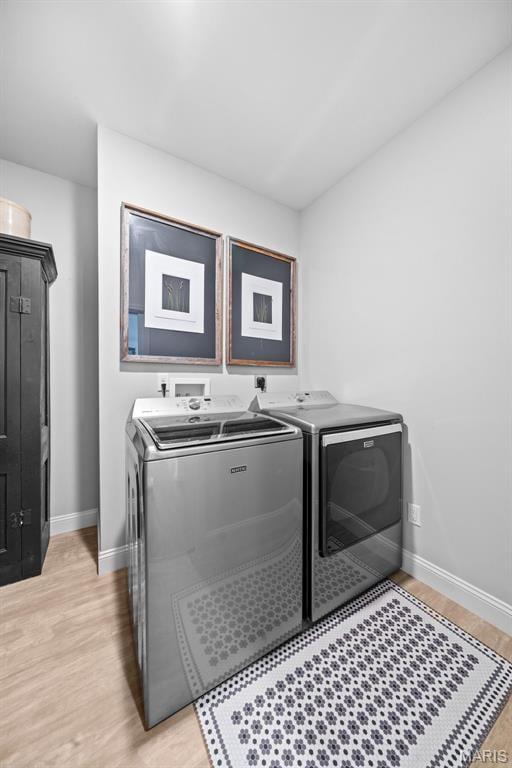 932 Colebrook Ct, Lake St Louis, MO 63367 - laundry area with washer and clothes dryer and light wood-style floors