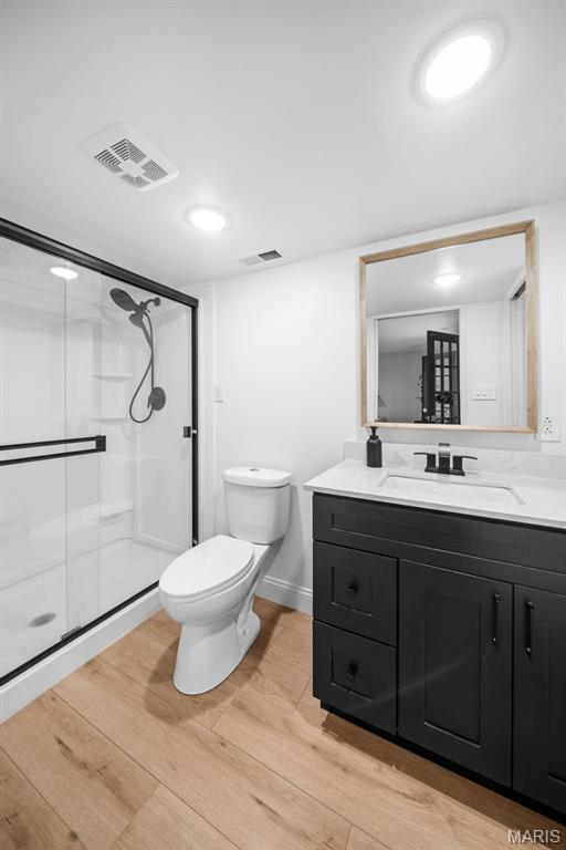 932 Colebrook Ct, Lake St Louis, MO 63367 - full bath featuring vanity, a stall shower, and wood finished floors