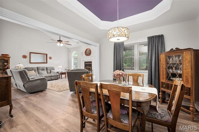 20220 Inverness Dr, Marthasville, MO 63357 - dining area featuring wood finished floors, ceiling fan, a tray ceiling, and ornamental molding