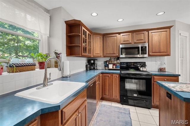 20220 Inverness Dr, Marthasville, MO 63357 - kitchen with appliances with stainless steel finishes, brown cabinetry, tasteful backsplash, dark countertops, and recessed lighting
