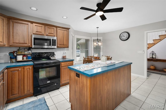 20220 Inverness Dr, Marthasville, MO 63357 - kitchen featuring black electric range oven, stainless steel microwave, dark countertops, decorative backsplash, and ceiling fan