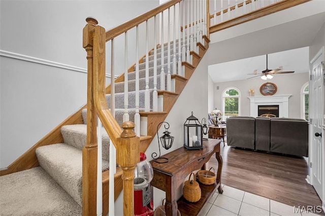 20220 Inverness Dr, Marthasville, MO 63357 - stairs with a ceiling fan, tile patterned flooring, and a fireplace