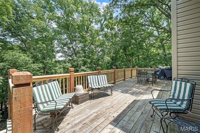 20220 Inverness Dr, Marthasville, MO 63357 - wooden terrace featuring outdoor dining space, a grill, and view of wooded area