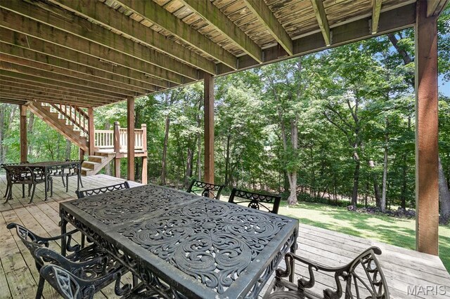 20220 Inverness Dr, Marthasville, MO 63357 - wooden terrace with outdoor dining area, stairs, view of scattered trees, and a yard