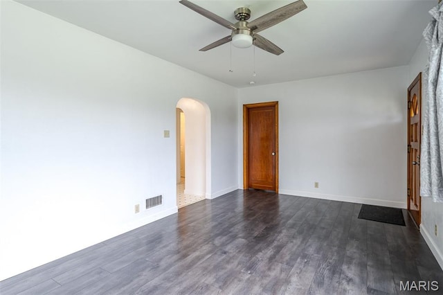 1407 E 5th St, Washington, MO 63090 - spare room with arched walkways, a ceiling fan, and dark wood finished floors