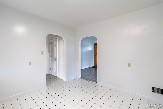 1407 E 5th St, Washington, MO 63090 - spare room featuring arched walkways and light flooring