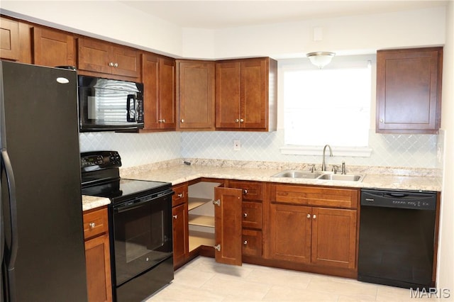 12574 Chardin Pl Unit 1, Tesson Ferry Township, MO 63128 - kitchen with black appliances, backsplash, light tile patterned floors, and brown cabinets