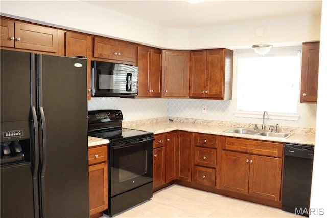 12574 Chardin Pl Unit 1, Tesson Ferry Township, MO 63128 - kitchen featuring black appliances, decorative backsplash, light stone counters, and brown cabinetry
