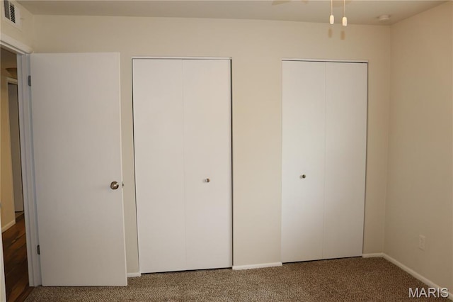 12574 Chardin Pl Unit 1, Tesson Ferry Township, MO 63128 - unfurnished bedroom with carpet flooring and two closets