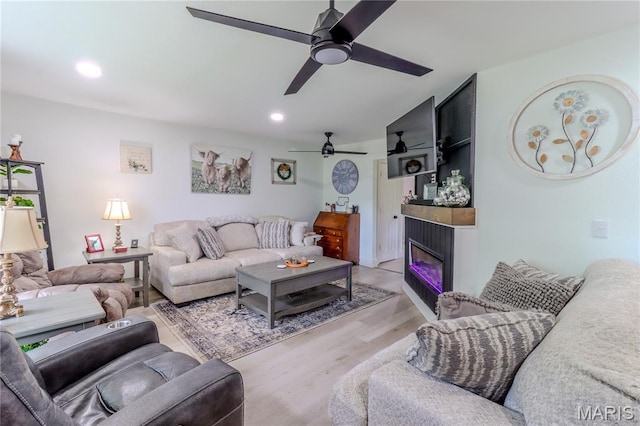 1304 Highland Dr, Rolla, MO 65401 - living room with ceiling fan, light wood-style flooring, a glass covered fireplace, and recessed lighting