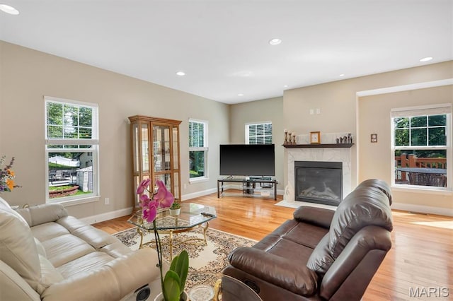 306 Essen Ln, Ballwin, MO 63021 - living room featuring plenty of natural light, recessed lighting, a premium fireplace, and light wood finished floors