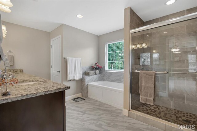 306 Essen Ln, Ballwin, MO 63021 - bathroom with marble finish floors, a garden tub, a stall shower, vanity, and recessed lighting