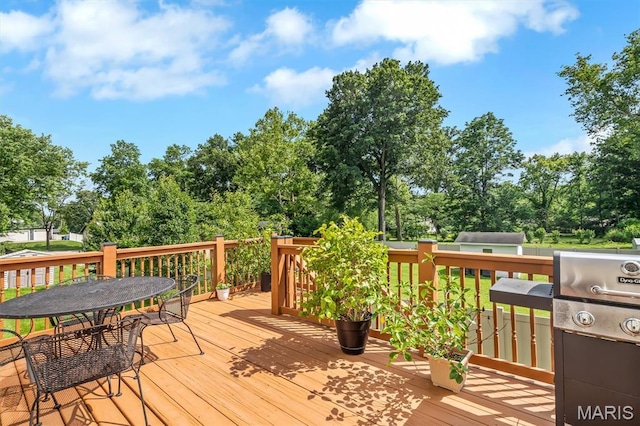 306 Essen Ln, Ballwin, MO 63021 - wooden terrace featuring outdoor dining space and view of wooded area