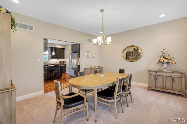 306 Essen Ln, Ballwin, MO 63021 - dining space featuring a chandelier, light colored carpet, and recessed lighting