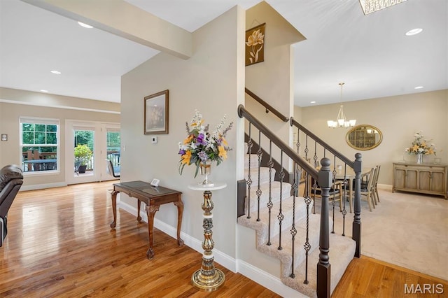 306 Essen Ln, Ballwin, MO 63021 - stairs featuring a chandelier, wood finished floors, and recessed lighting