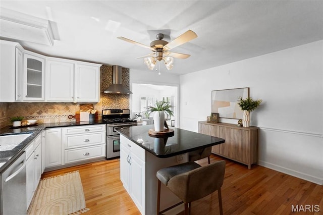 12330 Cape Cod Dr, Creve Coeur Township, MO 63146 - kitchen with wall chimney range hood, stainless steel appliances, decorative backsplash, white cabinetry, and a kitchen bar