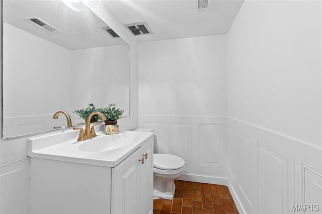 12330 Cape Cod Dr, Creve Coeur Township, MO 63146 - bathroom featuring vanity, a decorative wall, wainscoting, and tile patterned floors