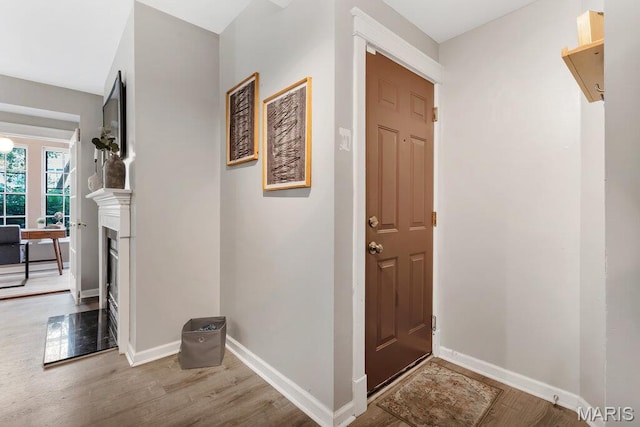 5858 Nina Pl # 1W, Saint Louis, MO 63112 - foyer with wood finished floors and a fireplace