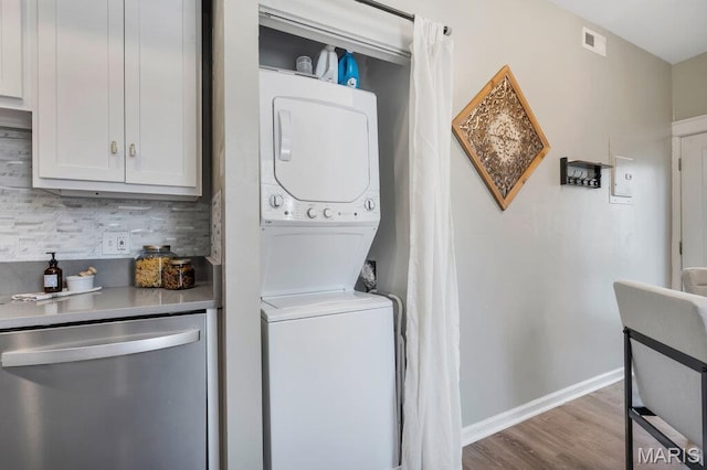 5858 Nina Pl # 1W, Saint Louis, MO 63112 - washroom featuring stacked washer and clothes dryer and wood finished floors