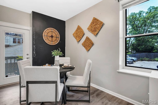 5858 Nina Pl # 1W, Saint Louis, MO 63112 - dining space featuring wood finished floors and baseboards