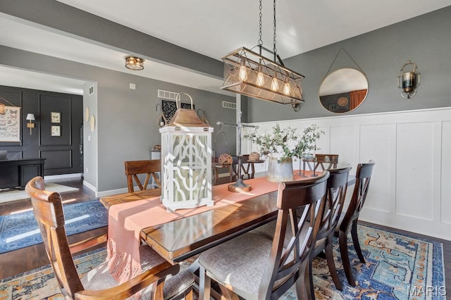 144 Wilmer Valley Dr, Wentzville, MO 63385 - dining room featuring a decorative wall, wainscoting, and wood finished floors