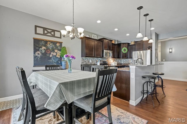 144 Wilmer Valley Dr, Wentzville, MO 63385 - dining room with a chandelier, dark wood-type flooring, and recessed lighting