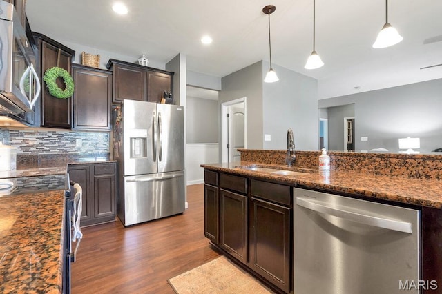 144 Wilmer Valley Dr, Wentzville, MO 63385 - kitchen with stainless steel appliances, dark wood-style floors, backsplash, dark brown cabinetry, and hanging light fixtures