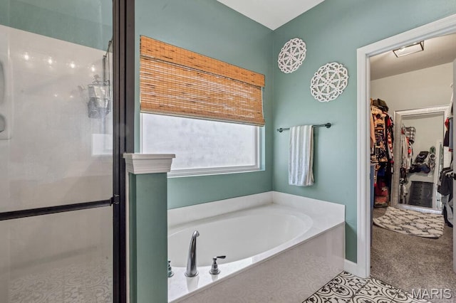 144 Wilmer Valley Dr, Wentzville, MO 63385 - bathroom featuring a garden tub, a shower stall, and a walk in closet