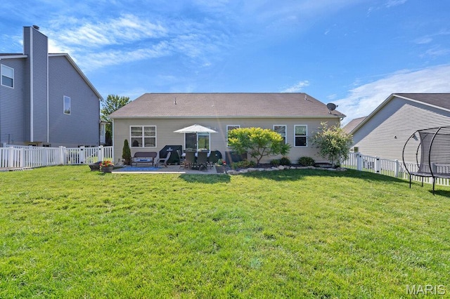 144 Wilmer Valley Dr, Wentzville, MO 63385 - back of house featuring a trampoline, a patio area, and a fenced backyard