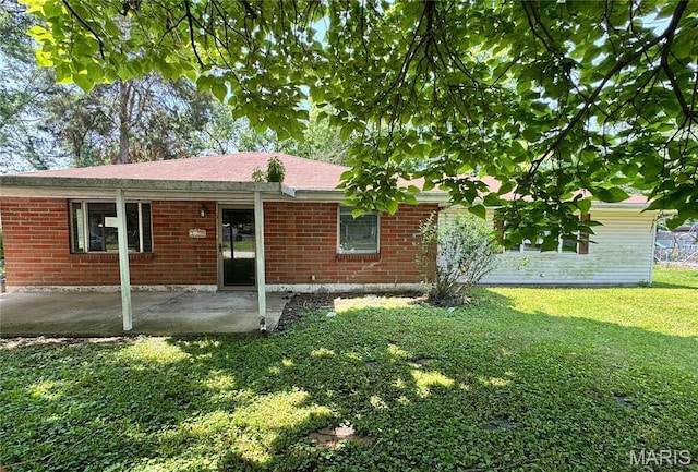 1820 Doris Ave, Cahokia, IL 62206 - view of front of home with a front lawn, a patio area, and brick siding