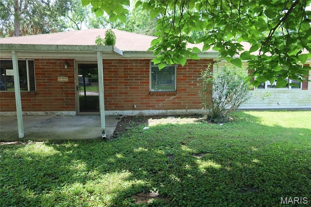 1820 Doris Ave, Cahokia, IL 62206 - back of house featuring a patio area, a yard, and brick siding