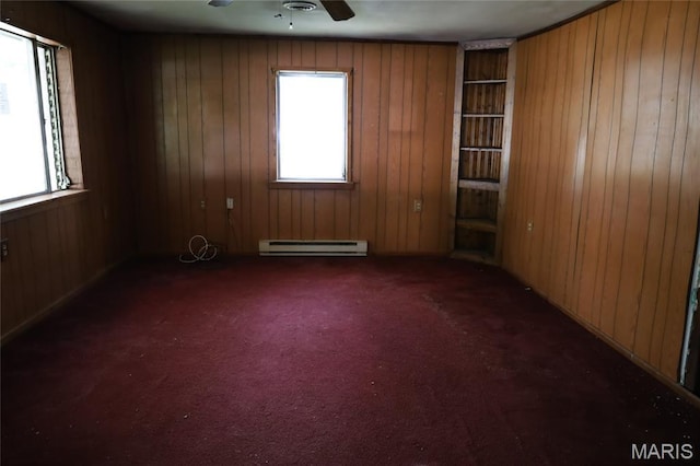 1820 Doris Ave, Cahokia, IL 62206 - carpeted spare room featuring a baseboard heating unit, ceiling fan, and wooden walls