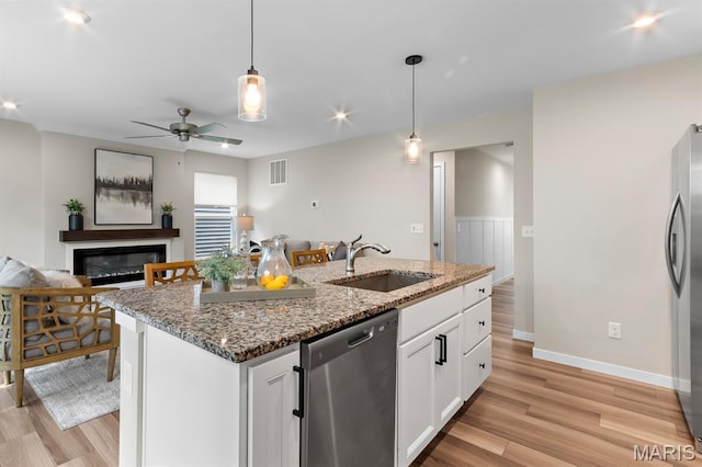 341 Newbridge Way, Ofallon, MO 63368 - kitchen featuring appliances with stainless steel finishes, open floor plan, light wood-type flooring, decorative light fixtures, and a ceiling fan