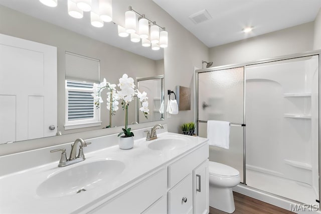 341 Newbridge Way, Ofallon, MO 63368 - bathroom with a shower stall, double vanity, and wood finished floors