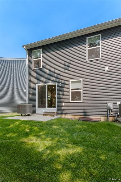 341 Newbridge Way, Ofallon, MO 63368 - rear view of house with a lawn and a patio
