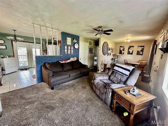 116 Charlene St, East Alton, IL 62024 - living room featuring washer / dryer, a ceiling fan, a textured ceiling, carpet floors, and tile patterned flooring
